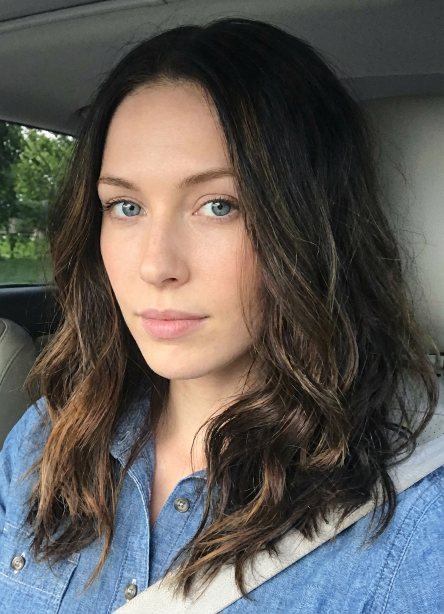 Casual close-up of woman with shoulder-skimming medium long layered hair styled in loose textured waves in natural daylight, generated by blondefilter.net