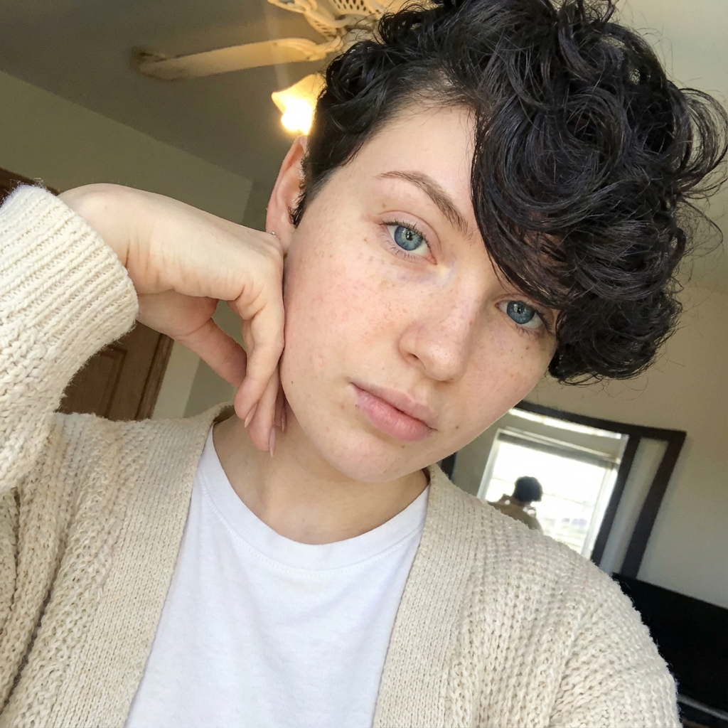 Casual selfie of woman with side-swept pixie short curly fringe wearing knit cardigan generated by blondefilter.net