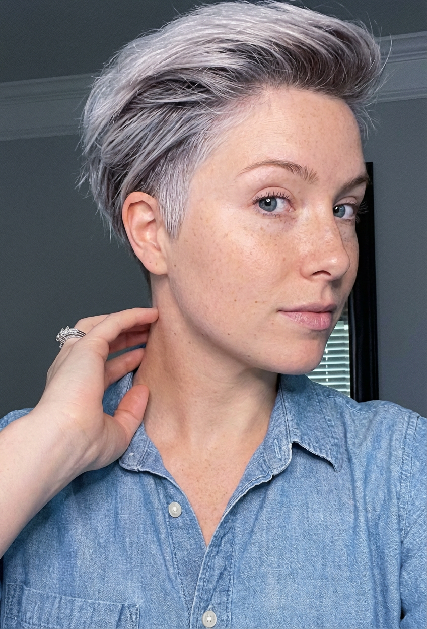 Side portrait of woman with short platinum pompadour and undercut in casual denim shirt indoors generated by blondefilter.net