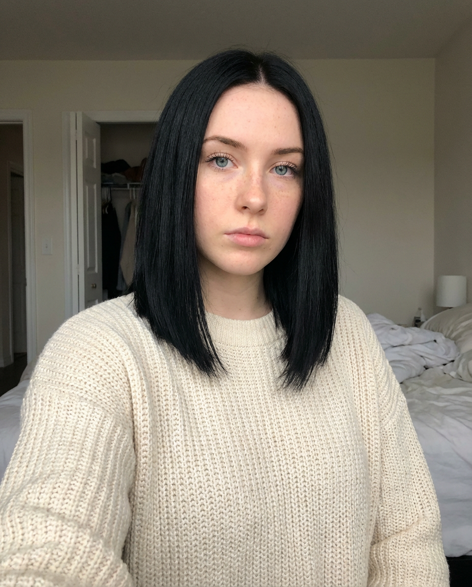 Front-facing woman with a sleek jet black shoulder-length lob and middle part generated by blondefilter.net