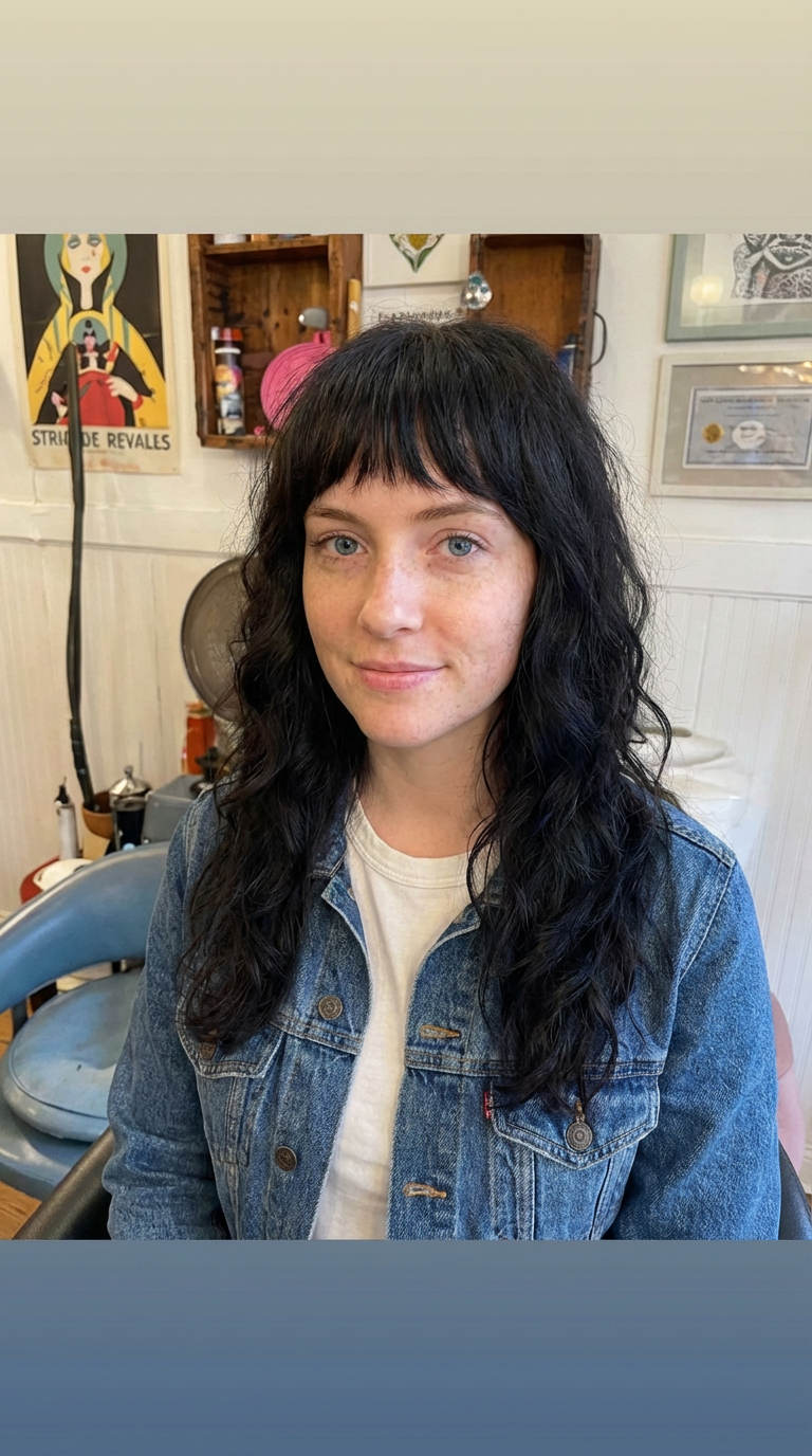 Salon photo of woman with tousled dark wavy shag and blunt bangs in a denim jacket generated by blondefilter.net